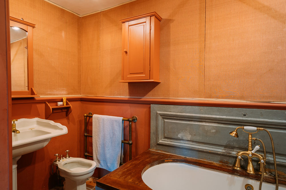 Bedroom 1 en-suite bathroom, bath with timber panelled surround, pedestal washbasin, bidet & WC.