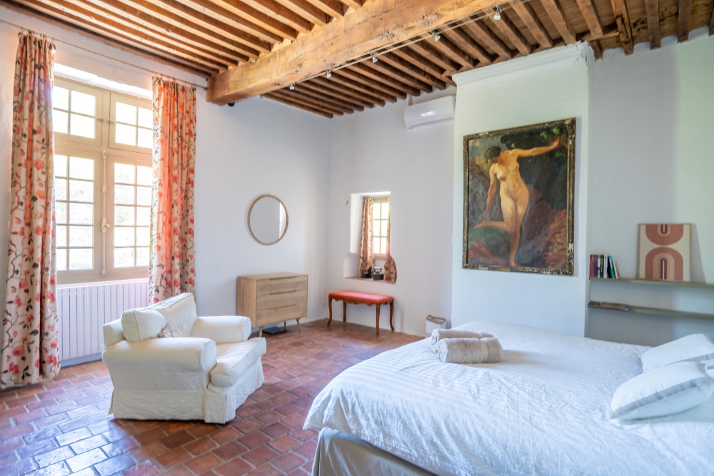 Bedroom 1, 5.3x5.2m, with mullioned windows, period terracotta floor, double cupboard.