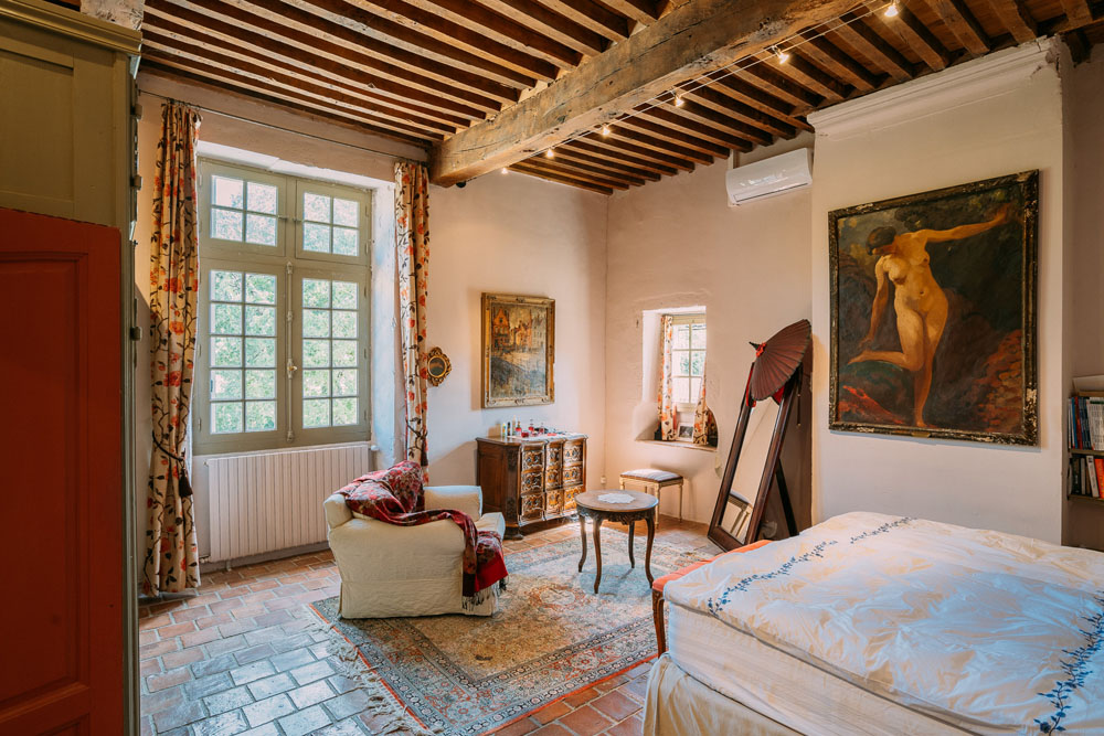 Bedroom 1, 5.3x5.2m, with mullioned windows, period terracotta floor, double cupboard.