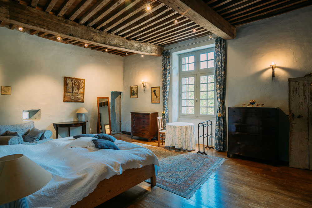 Bedroom 2, 6.8x5.3m, with chestnut flooring, wall of bookshelves, with plaster mouldings above fireplace. 